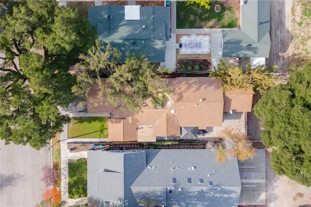 an aerial view of a house with a yard