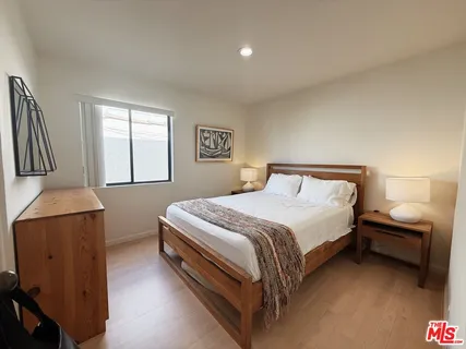 a bedroom with a bed and a cabinets