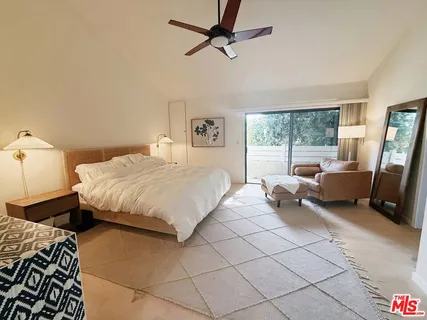 a bedroom with a bed and a couch