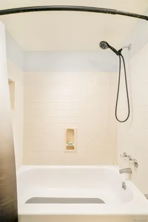 a bathroom with a bath tub with a shower