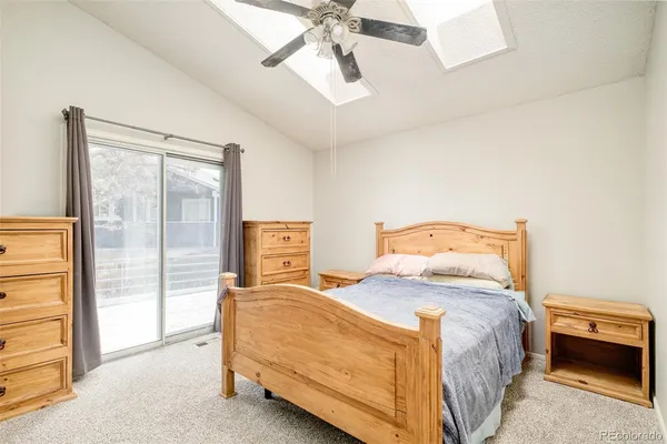a bedroom with a bed and a chandelier fan