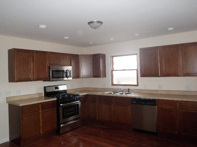7200 West Grand Ridge Road Verona, IL 60479 - Photo 4 of 14 a kitchen with granite countertop stainless steel appliances a sink a stove a microwave a counter space and cabinets