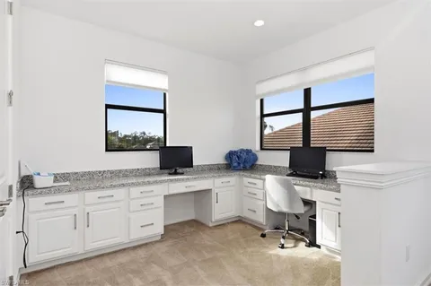 a kitchen with a sink cabinets and window