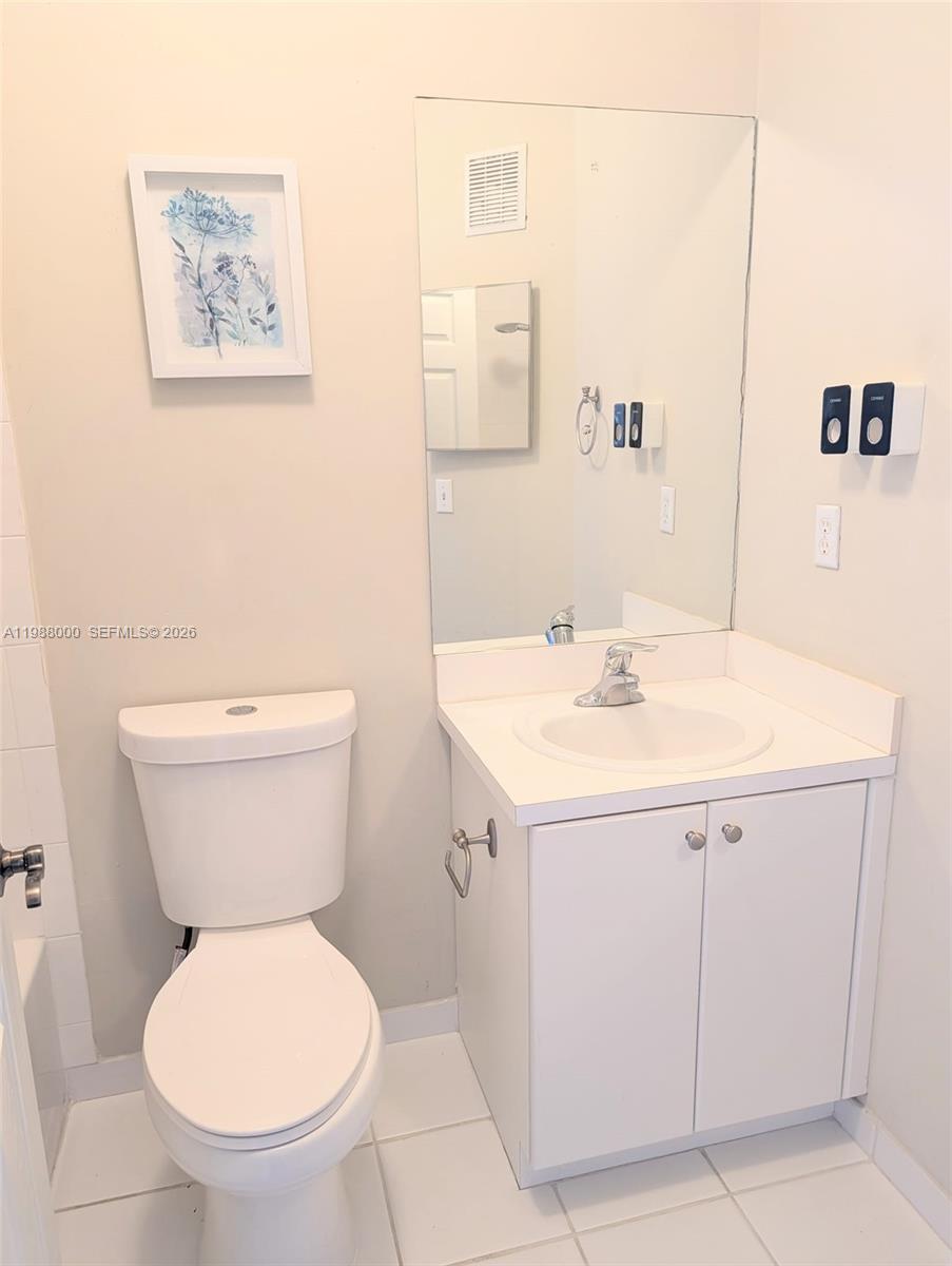 2320 Southeast 23rd Road, Unit 2320 Homestead, FL 33035 - Photo 11 of 11 a bathroom with a toilet sink and mirror