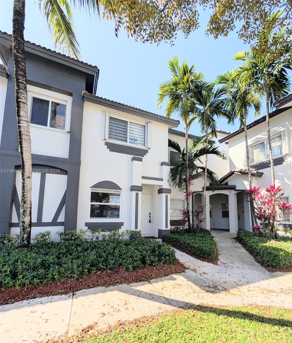 2320 Southeast 23rd Road, Unit 2320 Homestead, FL 33035 - Photo 2 of 11 a front view of a house with garden