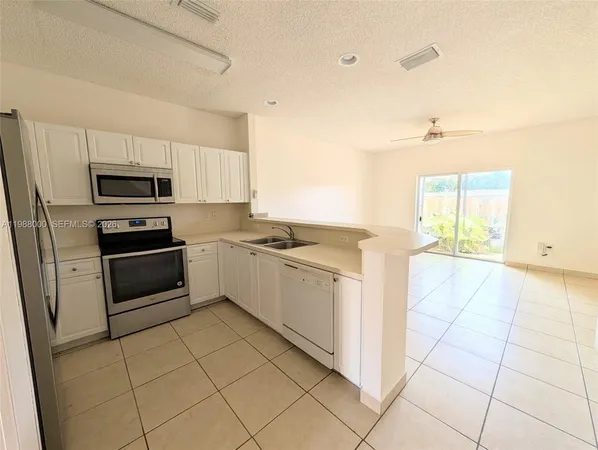 a kitchen with a stove a sink and a microwave