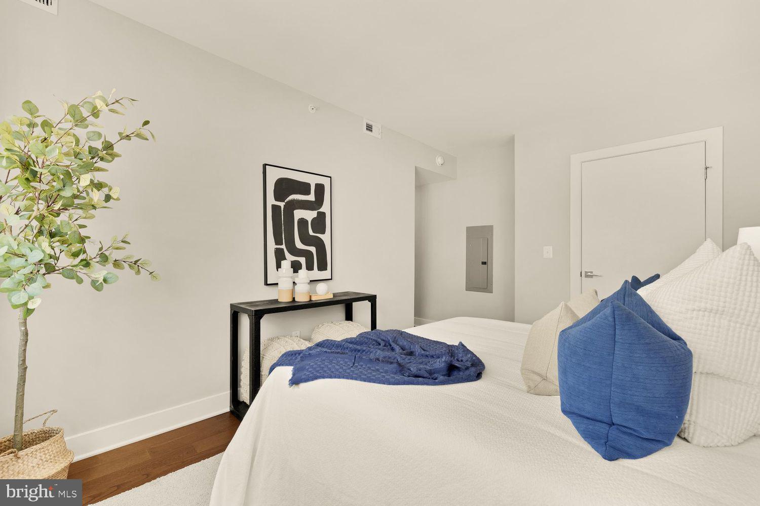 1311 13th Street Northwest, Unit 305 Washington, DC 20005 - Photo 19 of 29 a bedroom with a bed and a potted plant