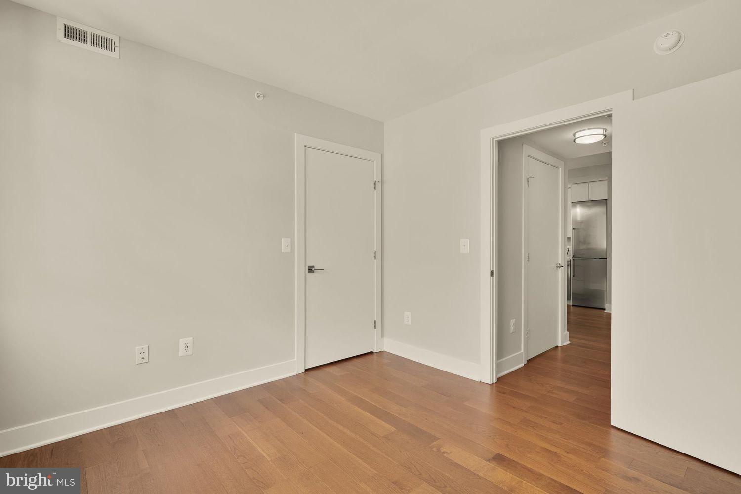 1311 13th Street Northwest, Unit 305 Washington, DC 20005 - Photo 24 of 29 a view of an empty room with wooden floor