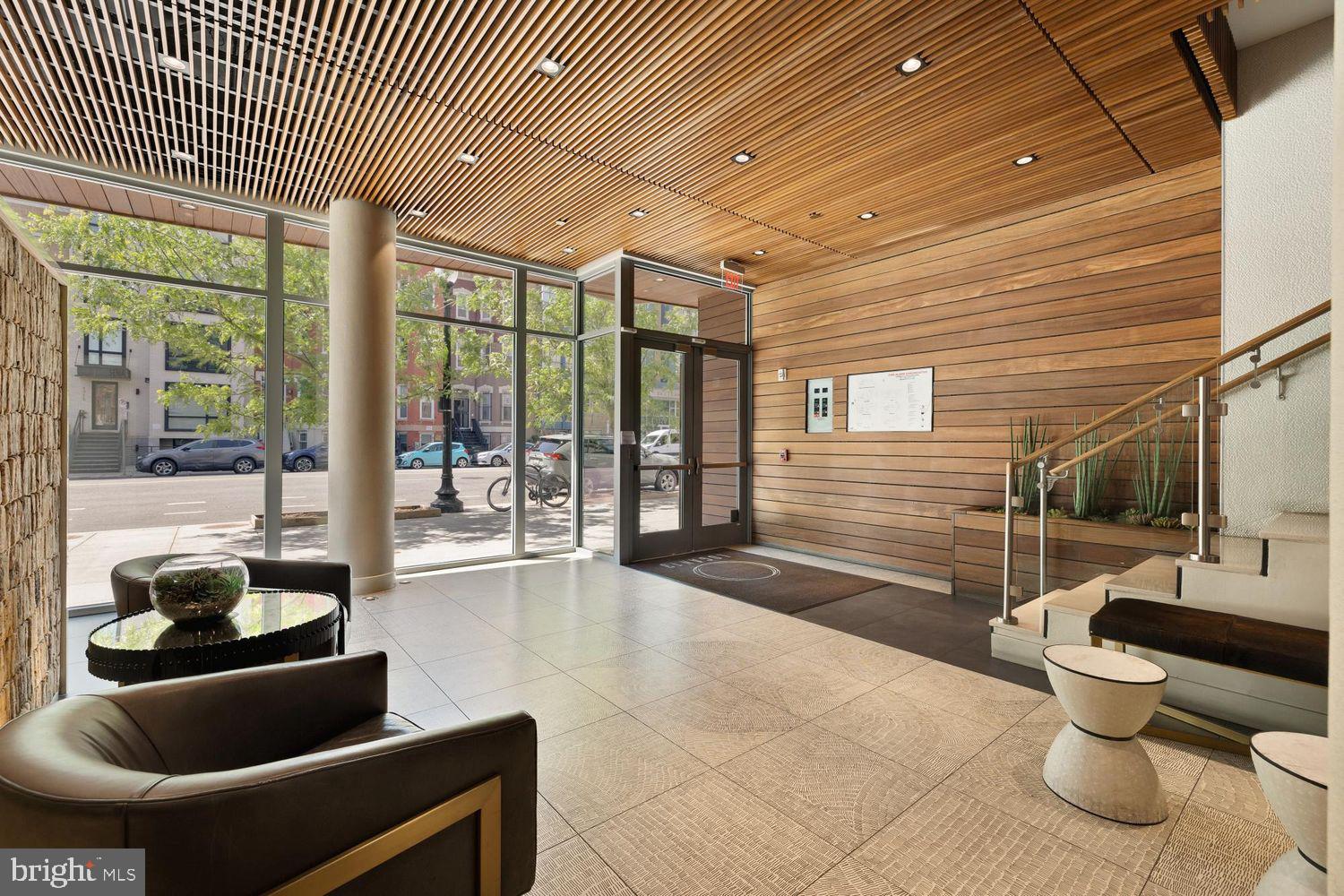 1311 13th Street Northwest, Unit 305 Washington, DC 20005 - Photo 4 of 29 a lobby with furniture and floor to ceiling window