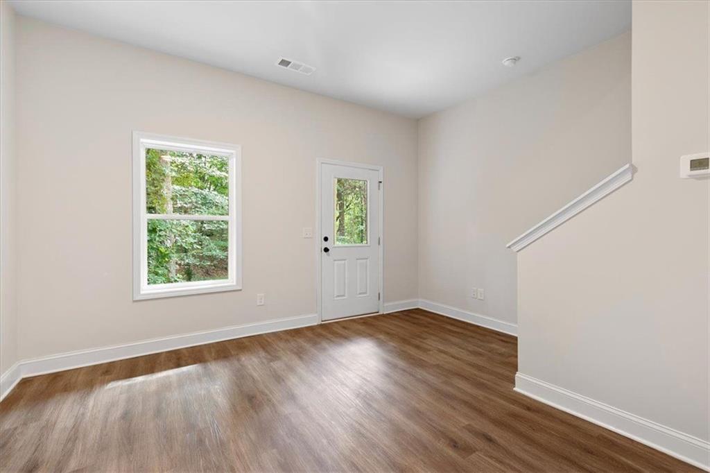 2486 Hidden Cove Court Gainesville, GA 30501 - Photo 13 of 29 an empty room with wooden floor and windows