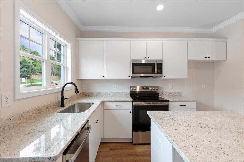 2486 Hidden Cove Court Gainesville, GA 30501 - Photo 16 of 29 a kitchen with stainless steel appliances granite countertop a sink stove and refrigerator