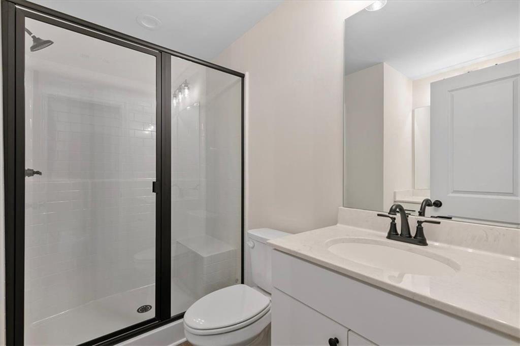 2486 Hidden Cove Court Gainesville, GA 30501 - Photo 21 of 29 a bathroom with a granite countertop sink toilet and shower
