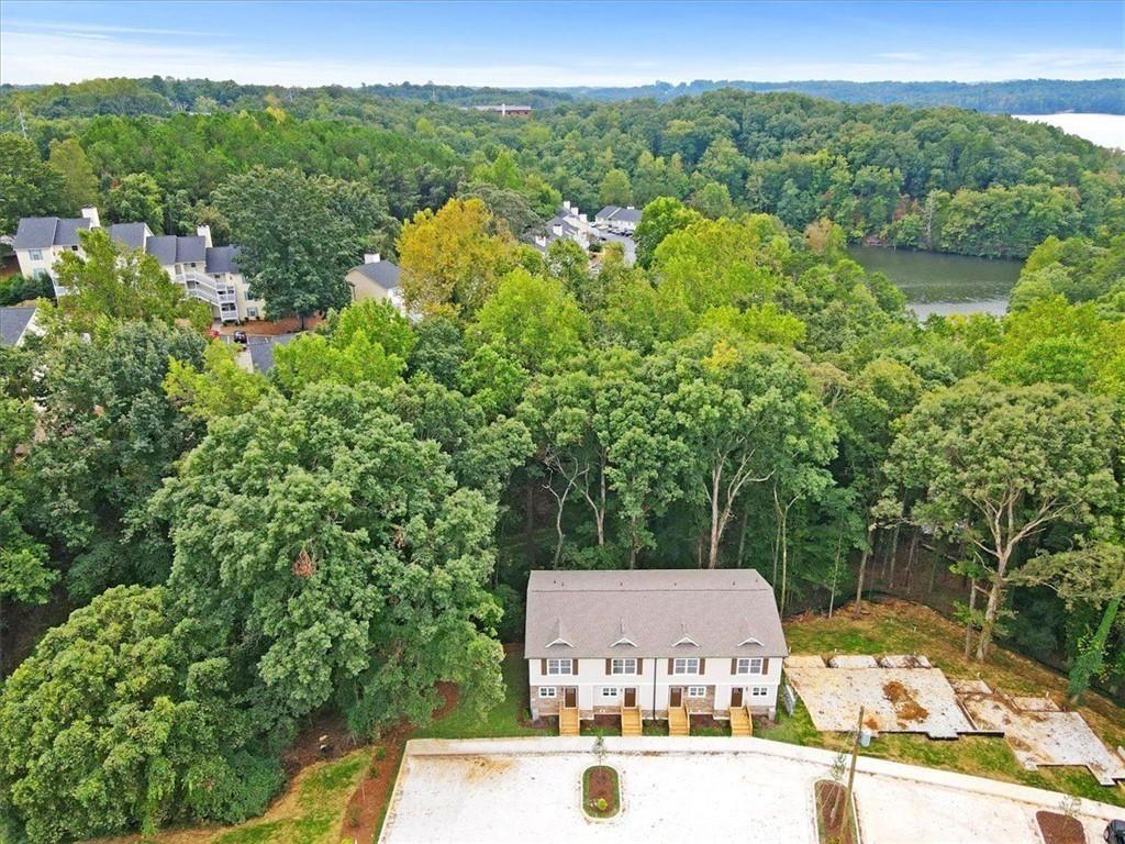 2486 Hidden Cove Court Gainesville, GA 30501 - Photo 6 of 29 a view of a lake with a building in the background