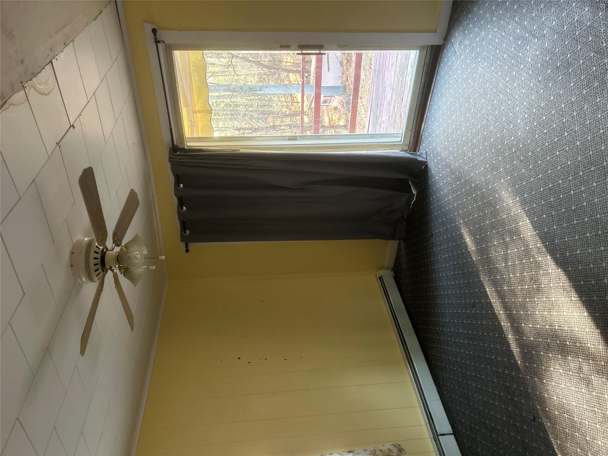 65 Eldred-Yulan Road Eldred, NY 12732 - Photo 13 of 22 an empty room with a ceiling fan and window