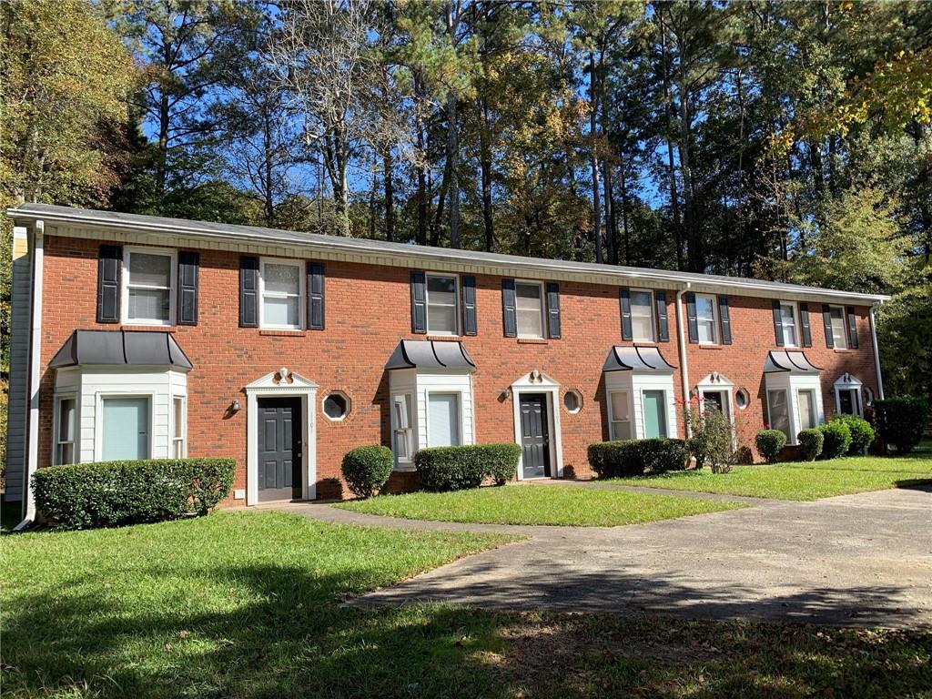 1103 Booth Court Southwest, Unit 1103 Marietta, GA 30008 - Photo 1 of 30 a front view of a house with a garden