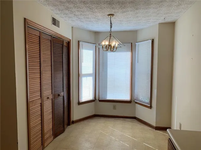 a view of a livingroom with a ceiling fan and window