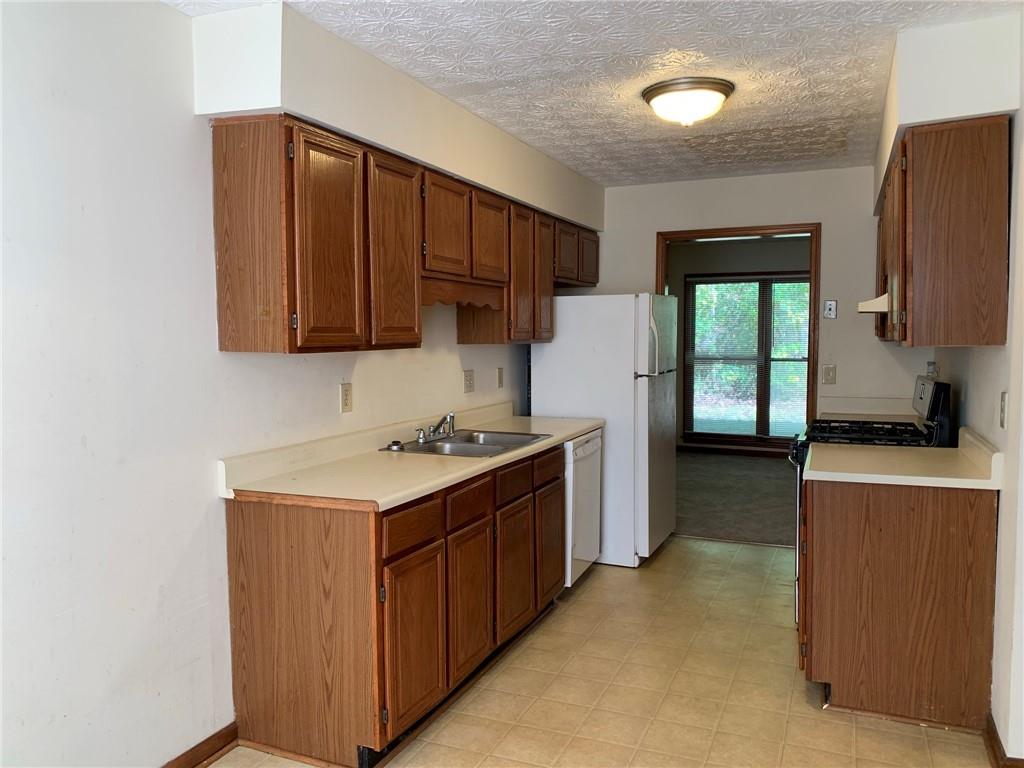 1103 Booth Court Southwest, Unit 1103 Marietta, GA 30008 - Photo 14 of 30 a kitchen with a stove and a refrigerator