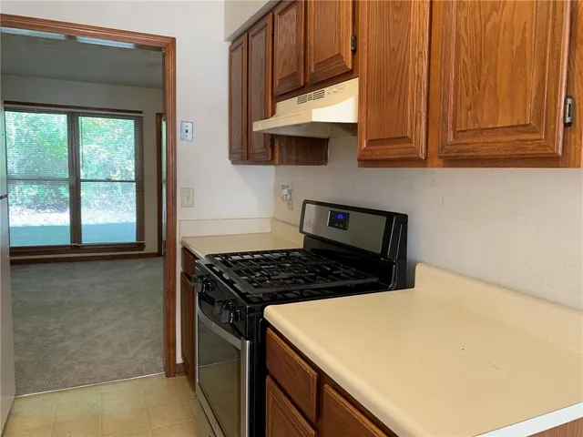 a kitchen with stainless steel appliances a stove a microwave and cabinets