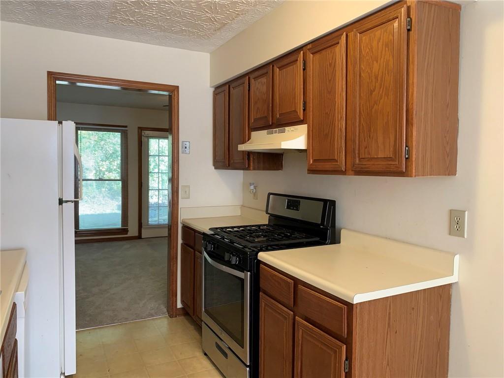 1103 Booth Court Southwest, Unit 1103 Marietta, GA 30008 - Photo 17 of 30 a kitchen with a stove and a cabinet