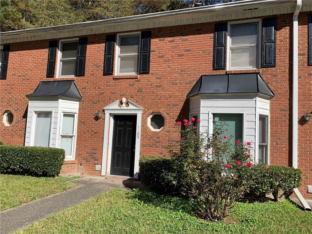 1103 Booth Court Southwest, Unit 1103 Marietta, GA 30008 - Photo 4 of 30 a front view of a house with garden