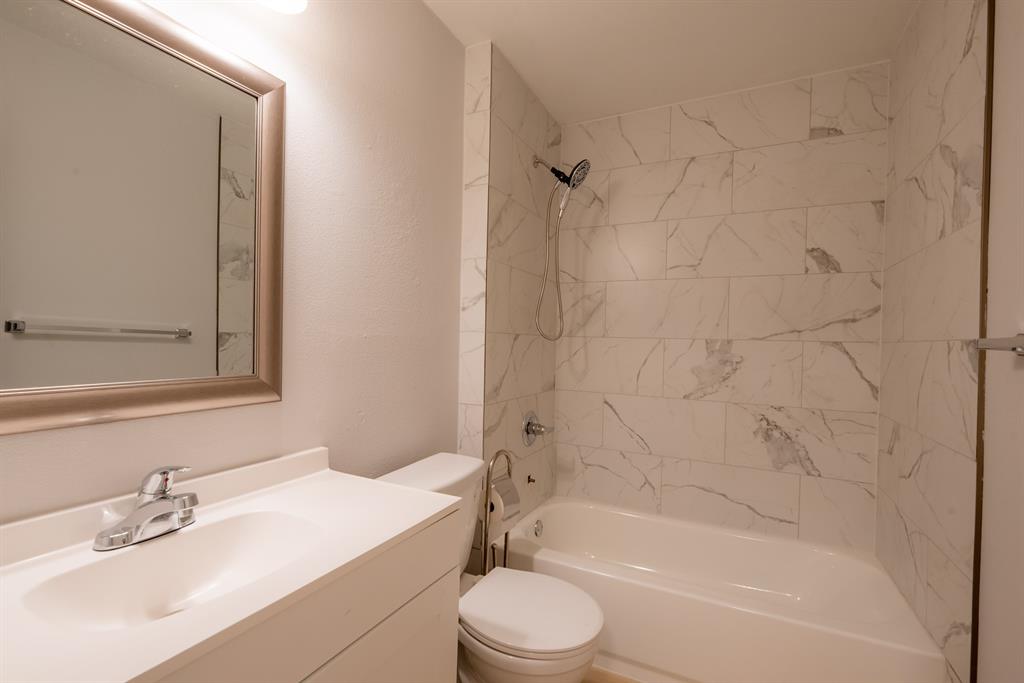 8708 Pineridge Drive, Unit A Austin, TX 78729 - Photo 13 of 15 a bathroom with a sink toilet and shower