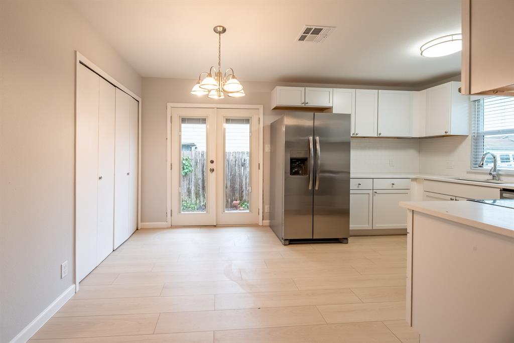 8708 Pineridge Drive, Unit A Austin, TX 78729 - Photo 3 of 15 a kitchen with stainless steel appliances a refrigerator sink and cabinets