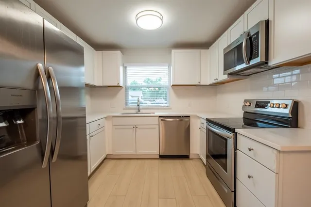 a kitchen with a sink microwave and refrigerator