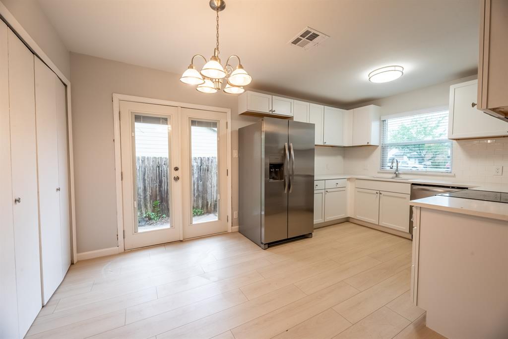 8708 Pineridge Drive, Unit A Austin, TX 78729 - Photo 5 of 15 a kitchen with stainless steel appliances a refrigerator sink and cabinets
