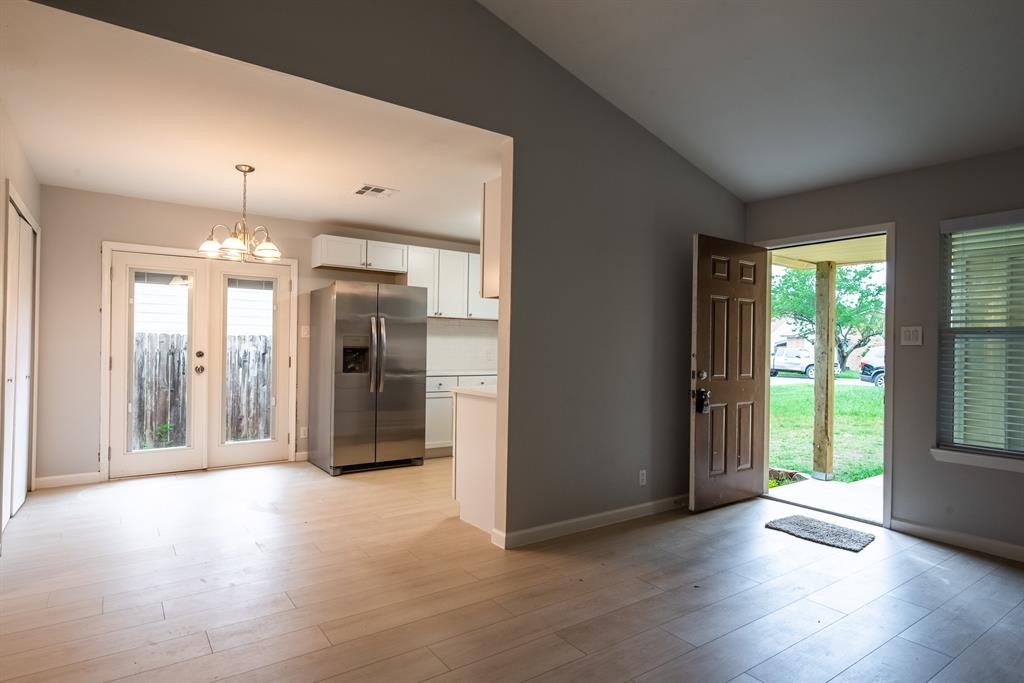 8708 Pineridge Drive, Unit A Austin, TX 78729 - Photo 6 of 15 a view of a hallway with wooden floor and a living room