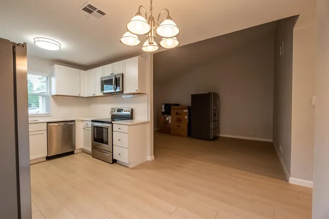 a kitchen with a stove cabinets and a refrigerator
