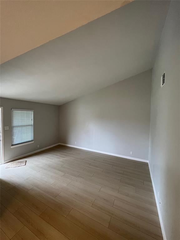 8708 Pineridge Drive, Unit A Austin, TX 78729 - Photo 10 of 15 a view of an empty room and wooden floor