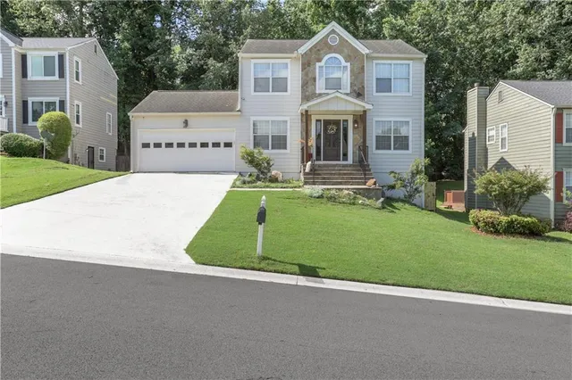 a front view of a house with a yard and garage