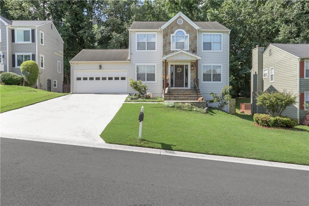 a front view of a house with a yard and garage