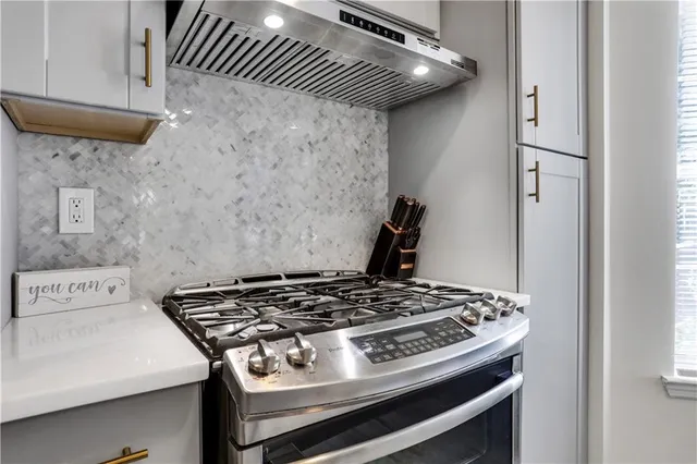 a stove top oven sitting inside of a kitchen