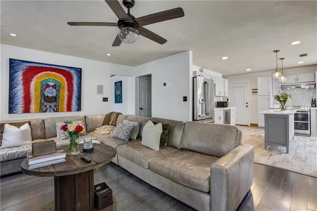 a living room with furniture and wooden floor