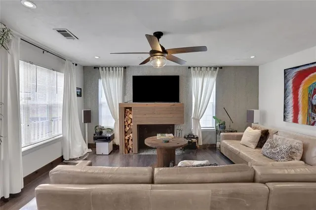 a living room with furniture a fireplace and a flat screen tv