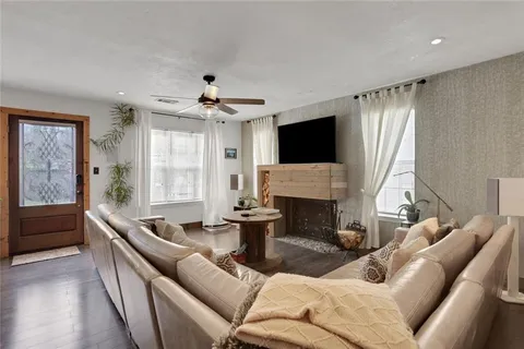 a living room with furniture a fireplace and a flat screen tv