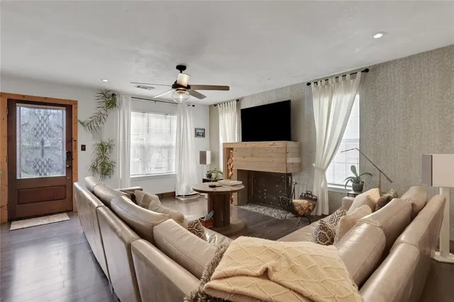 a living room with furniture a fireplace and a flat screen tv