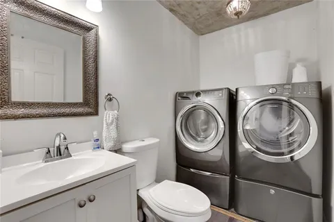 a bathroom with a sink a toilet and a mirror
