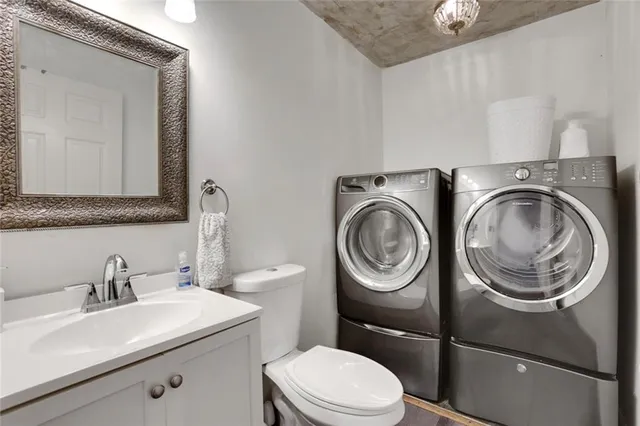 a bathroom with a sink a toilet and a mirror