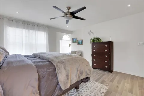 a bedroom with a bed and a ceiling fan