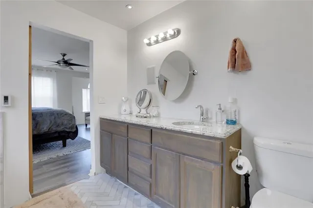a en suite bathroom with a double vanity sink and a mirror