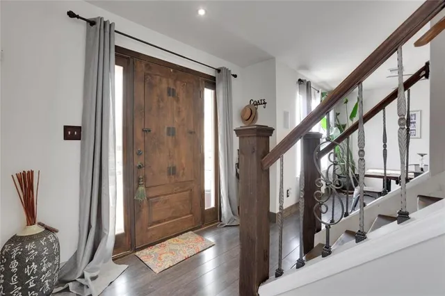 a view of an entryway with wooden floor and door