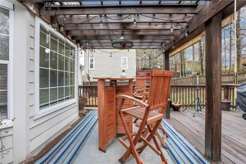 a view of a chairs and table in the balcony