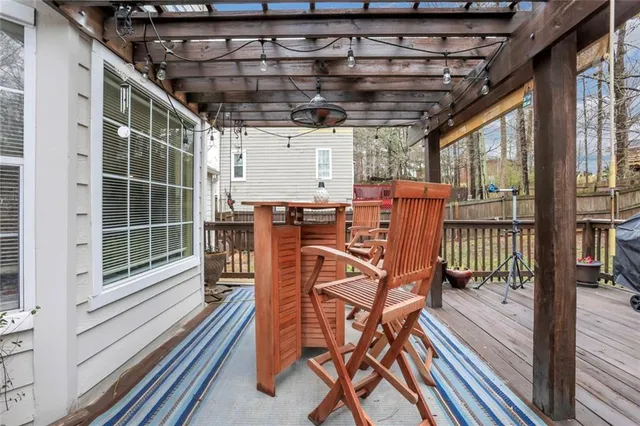 a view of a chairs and table in the balcony