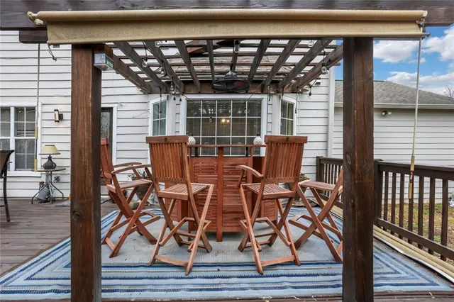 a view of a deck with table and chairs and wooden floor