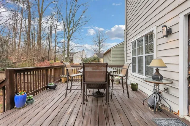a backyard of a house with table and chairs