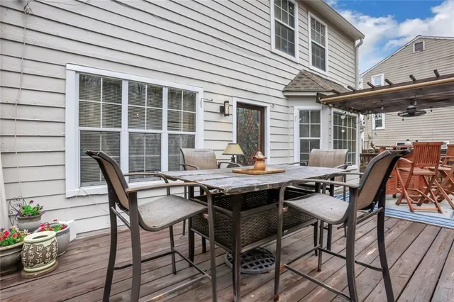 a view of a roof deck with couches chairs and wooden floor