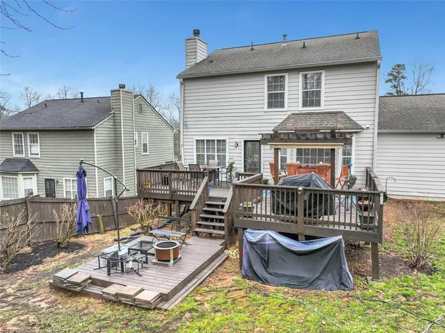 a view of a roof deck with table and chairs wooden floor and fence