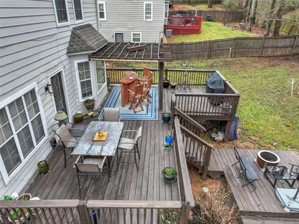 a backyard of a house with table and chairs